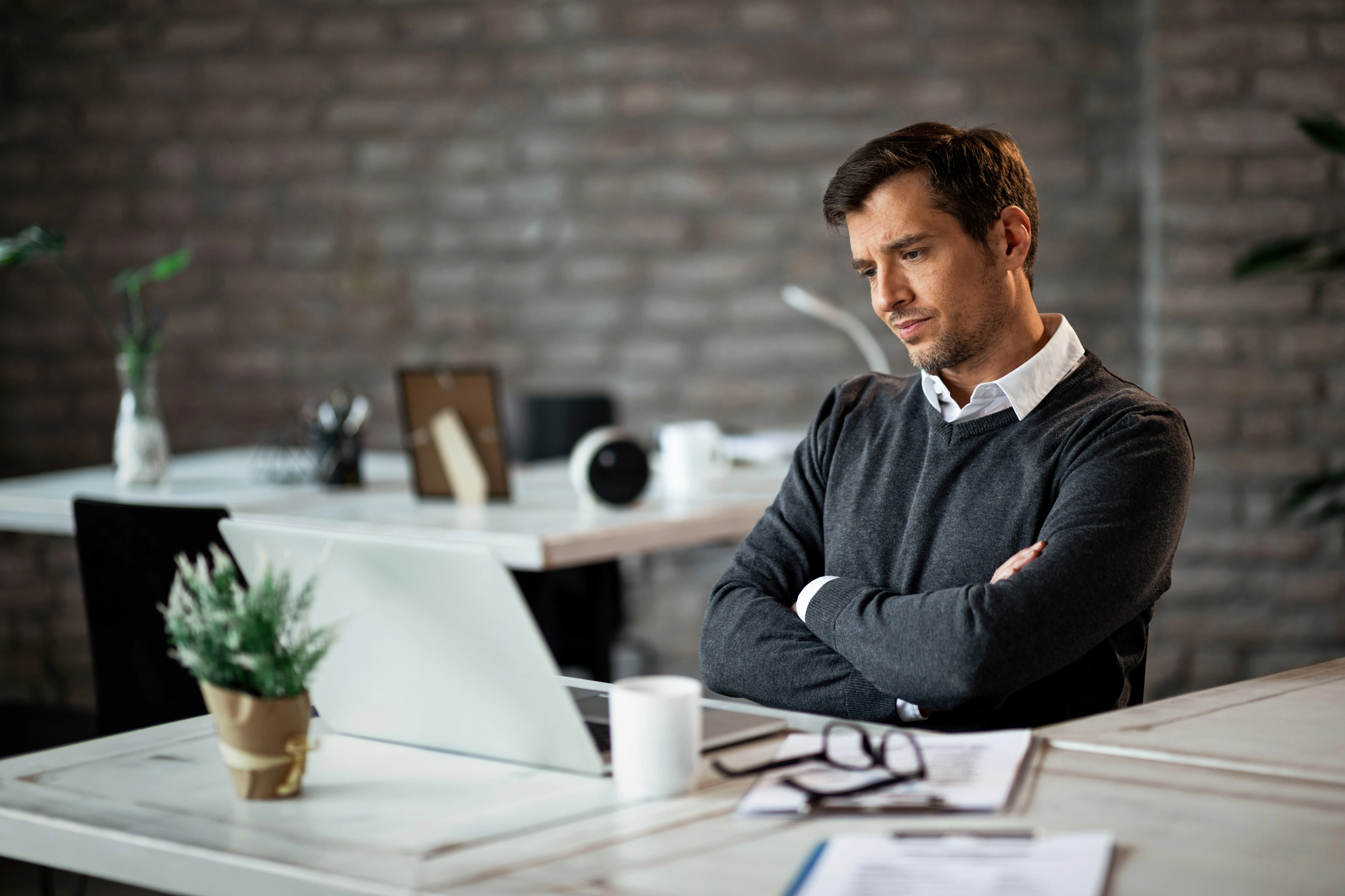 displeased-businessman-with-arms-crossed-reading-email-laptop-work.jpg