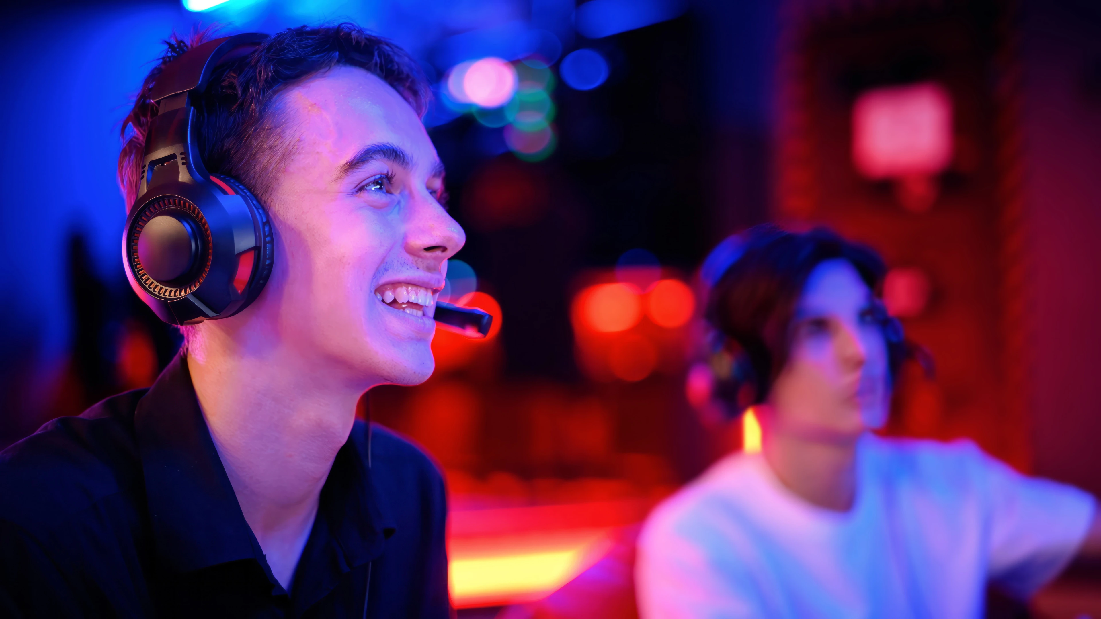 two-teen-friends-headphones-are-playing-game-console-using-gamepads-smiling (1).jpg