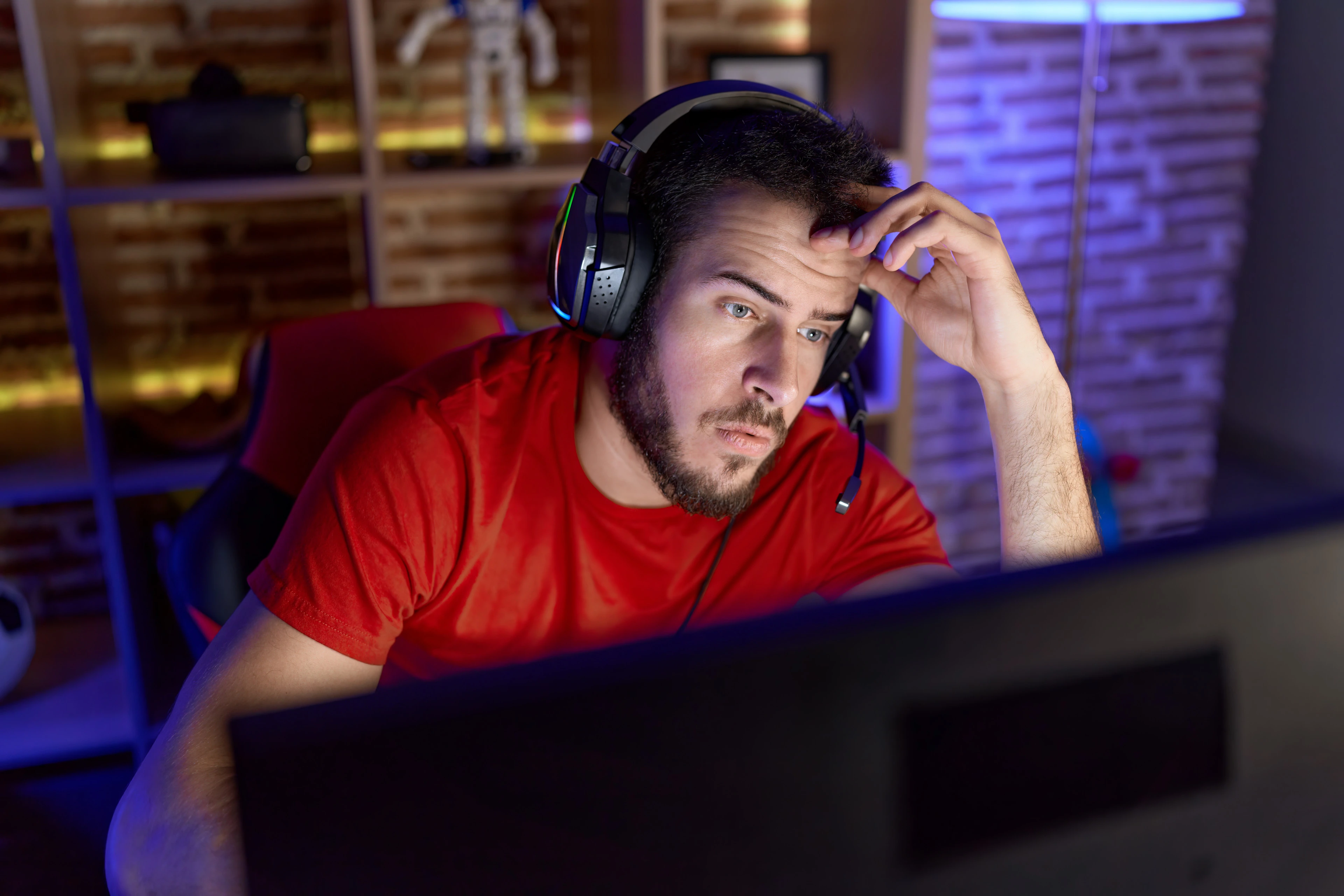 young-hispanic-man-streamer-stressed-using-computer-gaming-room.jpg